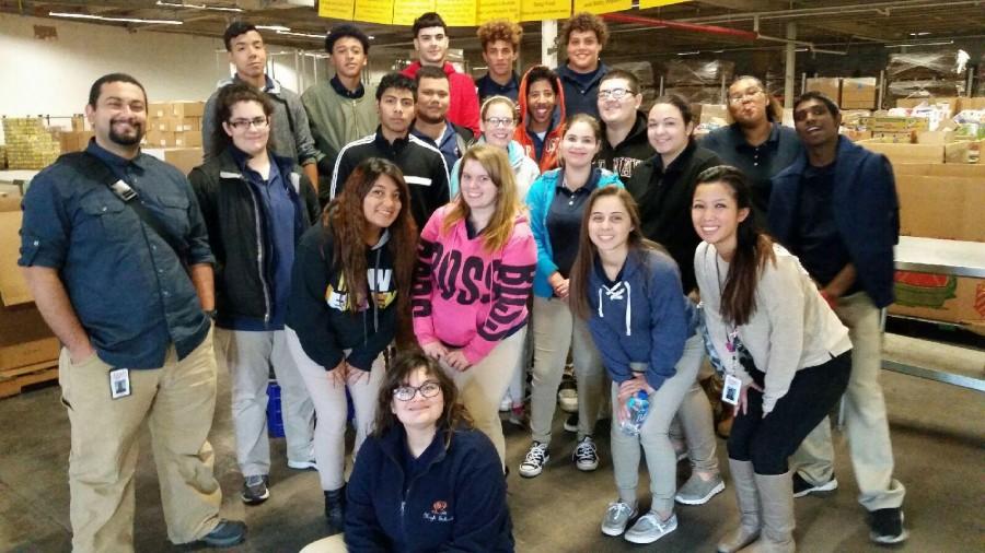 Ms. Dizon and Mr. Ghobrial with their students at the food bank.