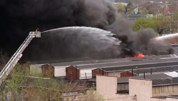 Firefighters putting water on the fire