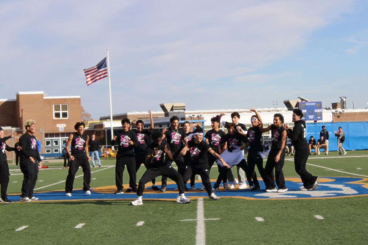 Senior, Nana-Kwame, dancing during boys cheer performance. 