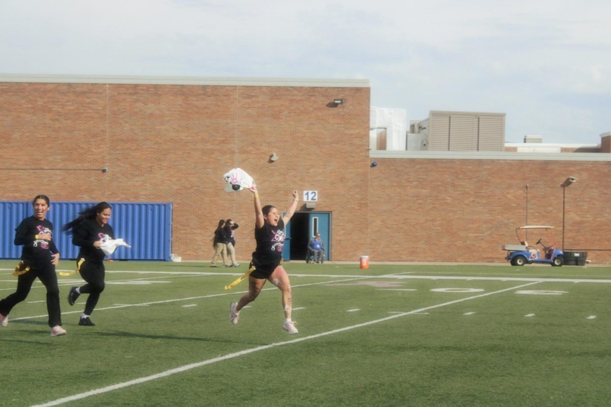 senior, Sofia S. , runs on the field. 