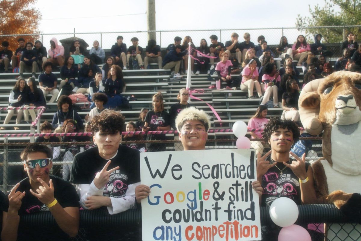 senior boys cheer on the game 